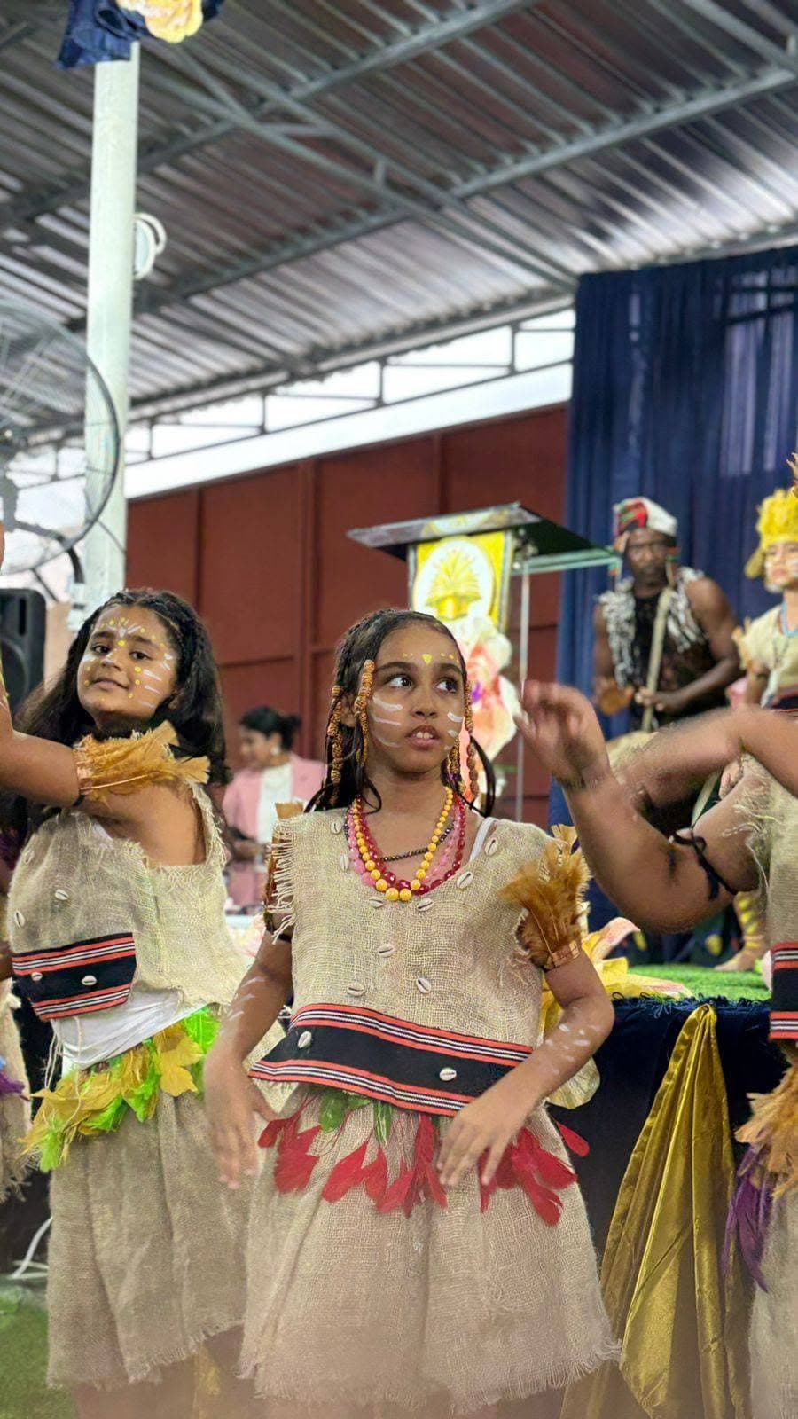 Students performing a traditional dance with a drummer
