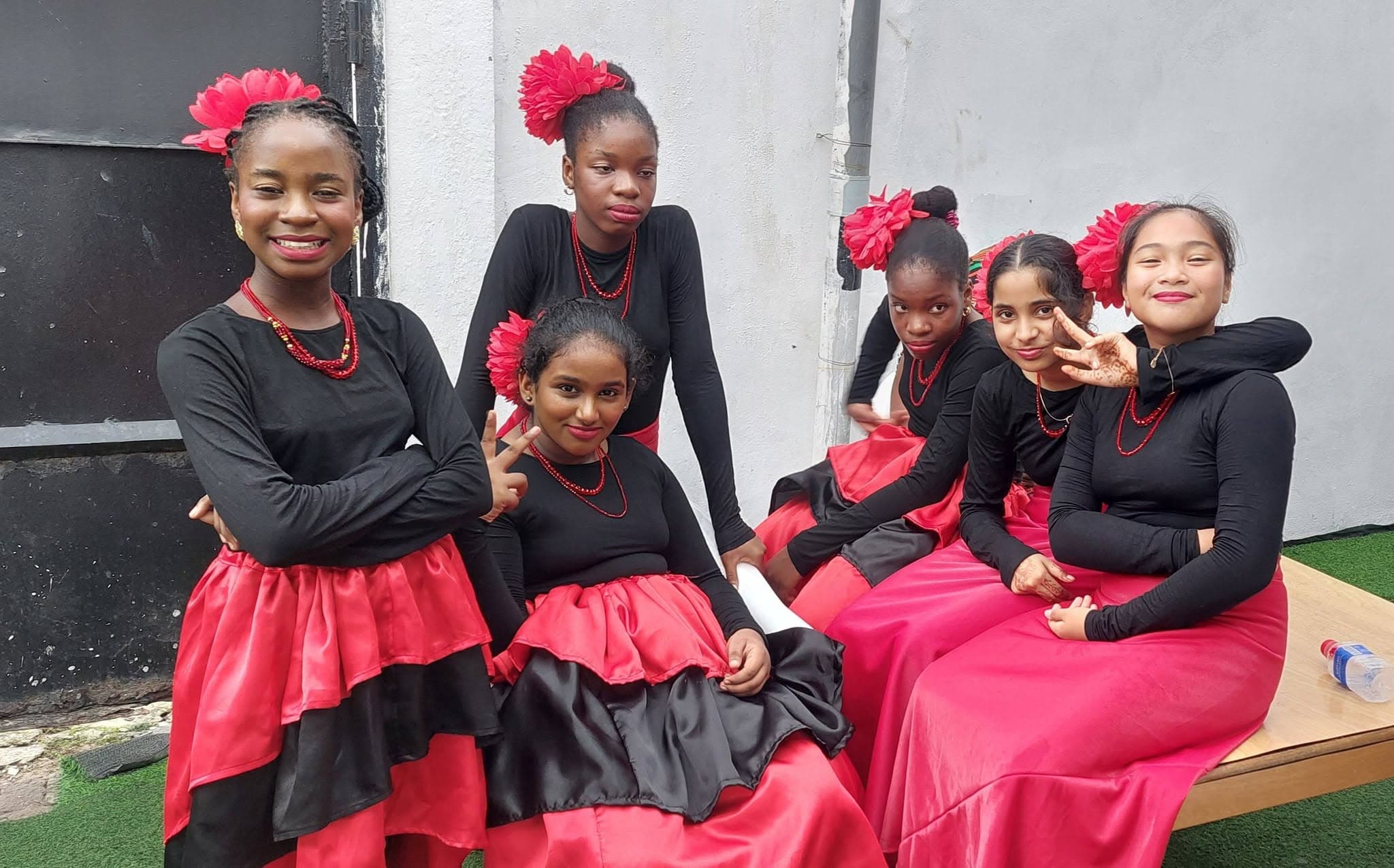 Dance troupe in red and black flamenco-style dresses