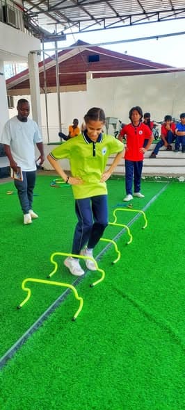 Student stepping through agility hurdles during PE