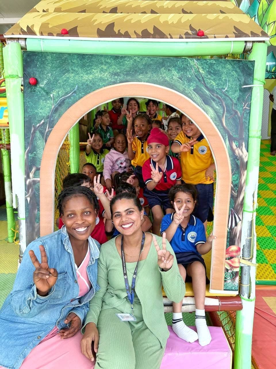 Teachers and students posing inside the play house on outing day
