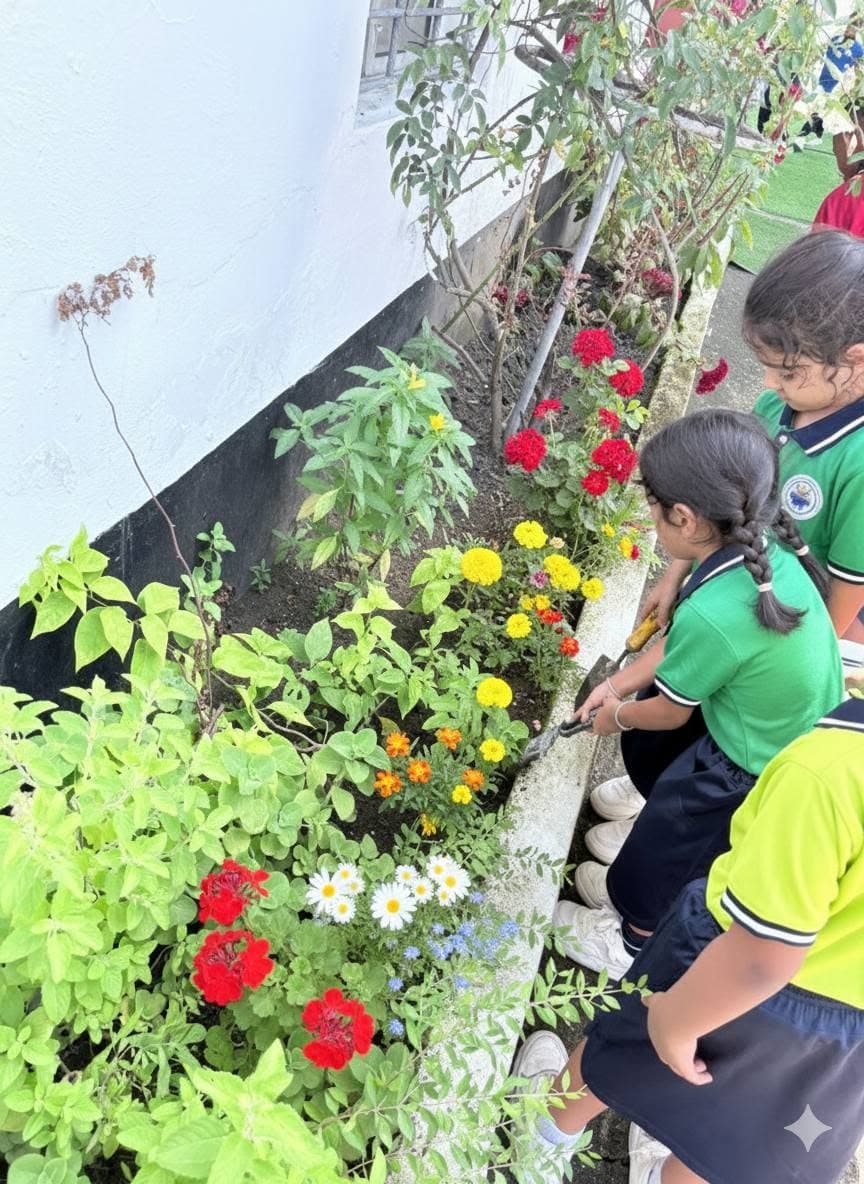 Students planting flowers along the school garden bed